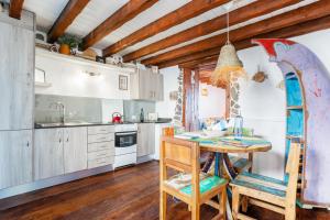 a kitchen with a table and chairs in a room at Eco Fisherman's Seafront Cottage in Arrieta
