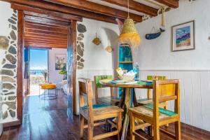 a dining room with a table and chairs at Eco Fisherman's Seafront Cottage in Arrieta