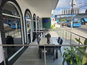 a restaurant with a table and chairs on a street at Hotel Via Espana in Panama City