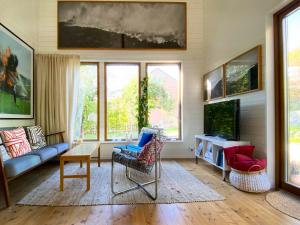 a living room with a couch and a tv at The Green House in Stockholm