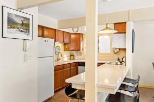 a kitchen with a white refrigerator and a table at 118 E. Bleeker Street Lower Level, Large Lower-Level Condo in Duplex with Private Deck in Aspen