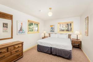 a bedroom with a bed and a dresser and two lamps at 118 E. Bleeker Street Lower Level, Large Lower-Level Condo in Duplex with Private Deck in Aspen