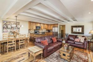 a living room with a couch and a table at Fasching Haus Unit 8, Deluxe Condo w/ A/C, Private Deck, 2 Blocks to Downtown in Aspen