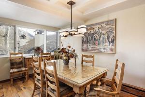 a dining room with a wooden table and chairs at Fasching Haus Unit 8, Deluxe Condo w/ A/C, Private Deck, 2 Blocks to Downtown in Aspen +6 photos