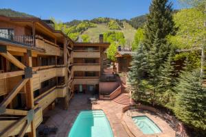 an aerial view of a resort with a swimming pool at Fasching Haus Unit 8, Deluxe Condo w/ A/C, Private Deck, 2 Blocks to Downtown in Aspen