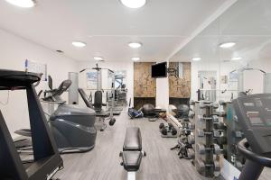 a gym with treadmills and machines in a room at Chateau Eau Claire Unit 8, Riverfront Condo, Walking Distance to Town in Aspen