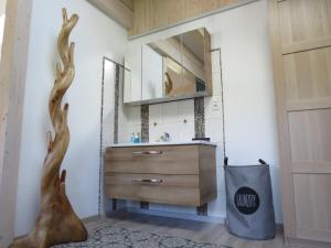 a bathroom with a vanity with deer antlers on the wall at Haus Stegen in Maria Alm am Steinernen Meer