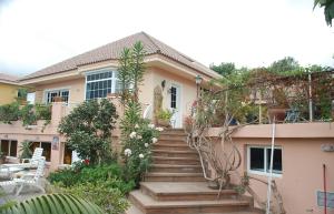 a house with stairs in front of it at Luxury Villa with Pool Sea and Mountain Views in Puerto de la Cruz in La Orotava