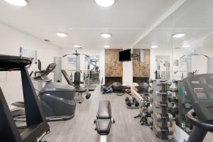 a gym with treadmills and machines in a room at Chateau Roaring Fork Unit 29, Sunny, Corner Condo with River Views in Aspen