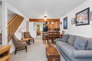 a living room with a couch and a table at Alpenblick 1, Three Level Townhouse with Fireplace, Private Balcony, and Great Location in Aspen