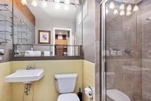 a bathroom with a toilet and a sink and a shower at Alpenblick 1, Three Level Townhouse with Fireplace, Private Balcony, and Great Location in Aspen