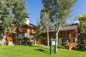 a house with a sign in front of it at Alpenblick 1, Three Level Townhouse with Fireplace, Private Balcony, and Great Location in Aspen