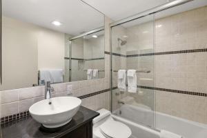 a bathroom with a sink and a toilet and a shower at Glory Hole Unit C, Remodeled condo w/ excellent location, wood-burning fireplace & new kitchen in Aspen