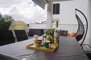 a table with a bottle of wine and glasses on it at Sobol Apartments 'Navis' with private jacuzzi in Crikvenica