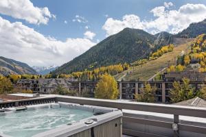 a hot tub on the roof of a building at Independence Square 308, Top Floor Hotel Room with Ideal Downtown Location in Aspen