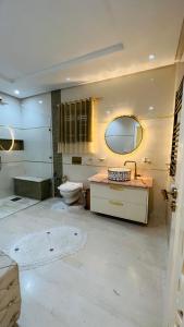 a bathroom with a sink and a toilet and a mirror at Maison Fathallah in Mahdia +40 photos