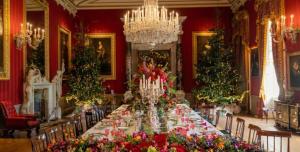 a long table in a red room with christmas trees at 1 Bed Charming Peak District Cottage Barn Near Alton Towers, Polar Bears, Chatsworth House in Leek