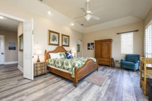 a bedroom with a bed and a ceiling fan at New Beachcombers at Luxurious Cinnamon Cove with Pool in Palm Coast +44 photos