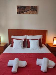 a bedroom with a large bed with two pillows on it at A casa do Almograve in Almograve