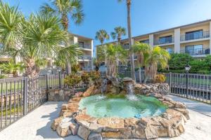 a fountain in front of a building with palm trees at Cozy Casita Beach Escape 850 A1A Unit 90 in St. Augustine