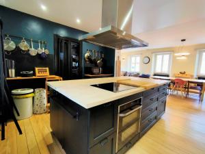 a kitchen with a sink and a stove top oven at Lancre / Maison kids-friendly en Alsace in Lutzelhouse