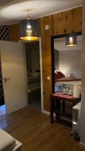 a room with a bed and a table and a mirror at Brandão House in Caparica