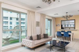 a living room with a couch and a table at BellaVista - Spectacular - 2 BR Penthouse - Boulevard Central - Panoramic Terrace & Burj Khalifa View in Dubai