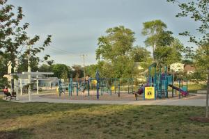 a playground in a park with children playing on it at Beachside Abode Crystal Beach in Fort Erie