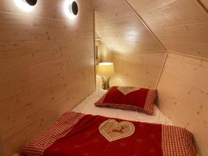 a bedroom with a bed in a wooden room at Chalet Lepenatka with Sauna - I feel Alps in Stahovica +24 photos