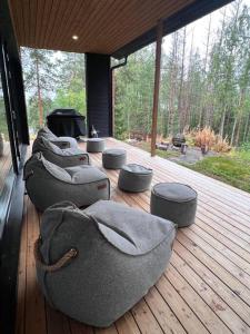 a row of bean bags on a wooden deck at Villa Aurinkorinne Himos in Jämsä