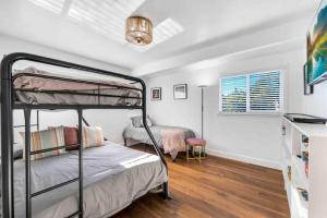 a bedroom with two bunk beds and a desk at Modern Family Farmhouse with Pool, Jacuzzi, Putting Green, Treehouse, Bocce and more in Thousand Oaks +50 photos