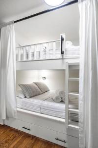 a white bunk bed in a room with white curtains at 5BR Train Theme Heated Pool Hot Tub EV BBQ in Spring