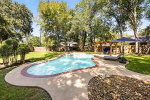 a swimming pool in a yard with a gazebo at 5BR Train Theme Heated Pool Hot Tub EV BBQ in Spring