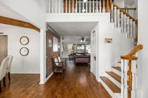 a hallway of a home with white walls and wood floors at 5BR Train Theme Heated Pool Hot Tub EV BBQ in Spring