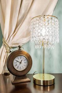 a clock sitting on a table next to a lamp at 5BR Train Theme Heated Pool Hot Tub EV BBQ in Spring