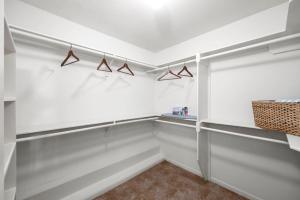 a walk in closet with white walls and hangers at 5BR Train Theme Heated Pool Hot Tub EV BBQ in Spring