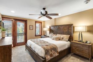 a bedroom with a large bed and a ceiling fan at Lion Square Lodge East 313 in Vail