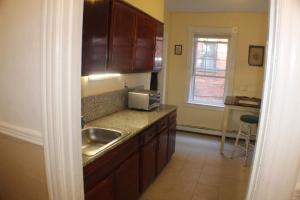 a kitchen with a sink and a microwave at West End Haven in Hartford +76 photos