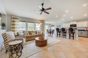 a living room with a couch and a table at Fruit Cove Vacation Rental with Private Hot Tub! in Fleming Island