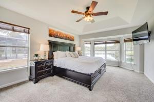 a bedroom with a bed and a ceiling fan at Fruit Cove Vacation Rental with Private Hot Tub! in Fleming Island