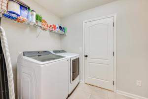 a laundry room with a washer and dryer at Fruit Cove Vacation Rental with Private Hot Tub! in Fleming Island