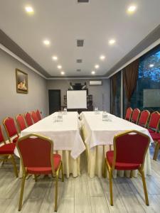 a conference room with a table and chairs and a screen at Grand Hotel Kapan, Armenia in Kapan +196 photos
