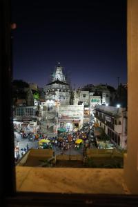 a view of a city at night with a building at Baba Palace - A Heritage Hotel, Udaipur in Udaipur