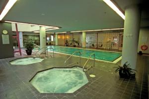 a large swimming pool in a building with a hot tub at WorldMark Vancouver The Canadian in Vancouver