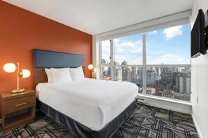 a hotel room with a bed and a large window at WorldMark Vancouver The Canadian in Vancouver +20 photos