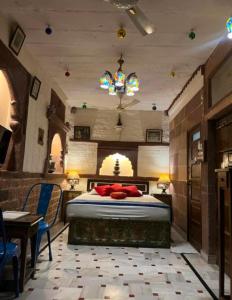 a bedroom with a bed and a table and chairs at Banasa Heritage Haveli in Jodhpur