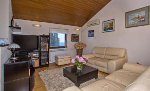 a living room with two couches and a tv at Villa Maria in Dubrovnik