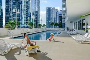 a group of people in the pool at a hotel at Modern 1 Bed in the Heart of Brickell With Free Parking in Miami
