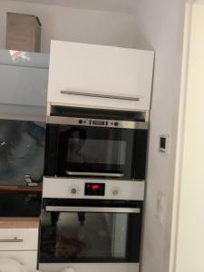 a microwave oven sitting inside of a kitchen at Messe Apartment in Hannover