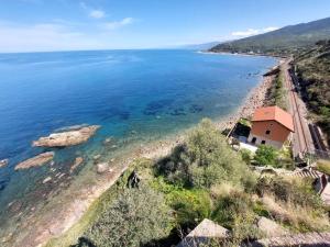 a house on the shore of a body of water at Ama Finale holiday home in Finale